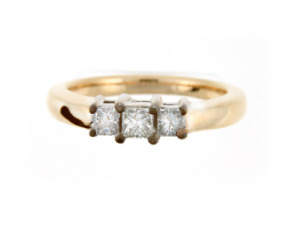 Three stone princess diamond engagement ring in yellow gold.