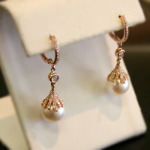 Pearl drop earrings with diamonds in rose gold.