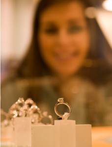 woman looking at rings in jewelry shop window