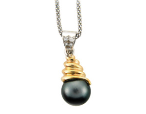 Black pearl and diamond pendant in yellow and white gold.