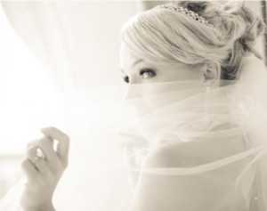 bride with diamond engagement ring and veil