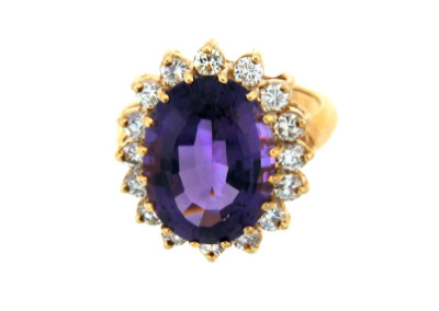 Oval amethyst and diamond ring in yellow gold.