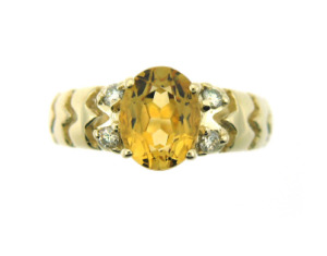 Oval citrine and diamond ring in yellow gold.