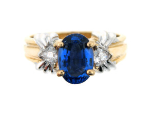 Oval sapphire and diamond ring in white and yellow gold.