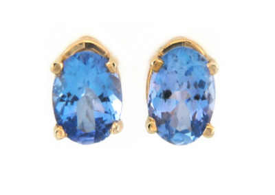 Oval cut blue topaz earrings in yellow gold.