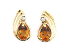 Pear shape citrine and diamond earrings in yellow gold.