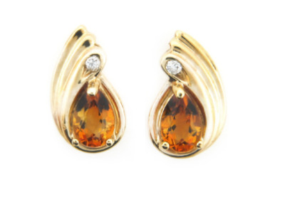 Pear shape citrine and diamond earrings in yellow gold.