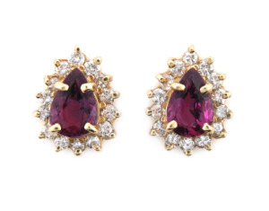 Pear cut ruby and diamond earrings in yellow gold.