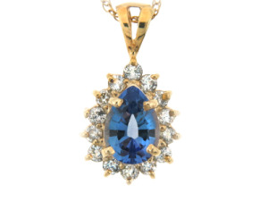 Pear cut sapphire and diamond pendant in yellow gold.