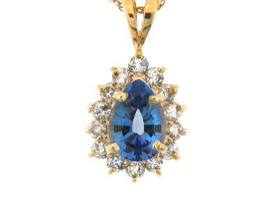 Pear cut sapphire and diamond pendant in yellow gold.