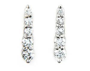 Round brilliant cut diamond journey earrings in white gold.
