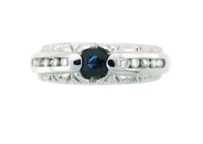 Round sapphire ring with channel set diamonds in white gold.